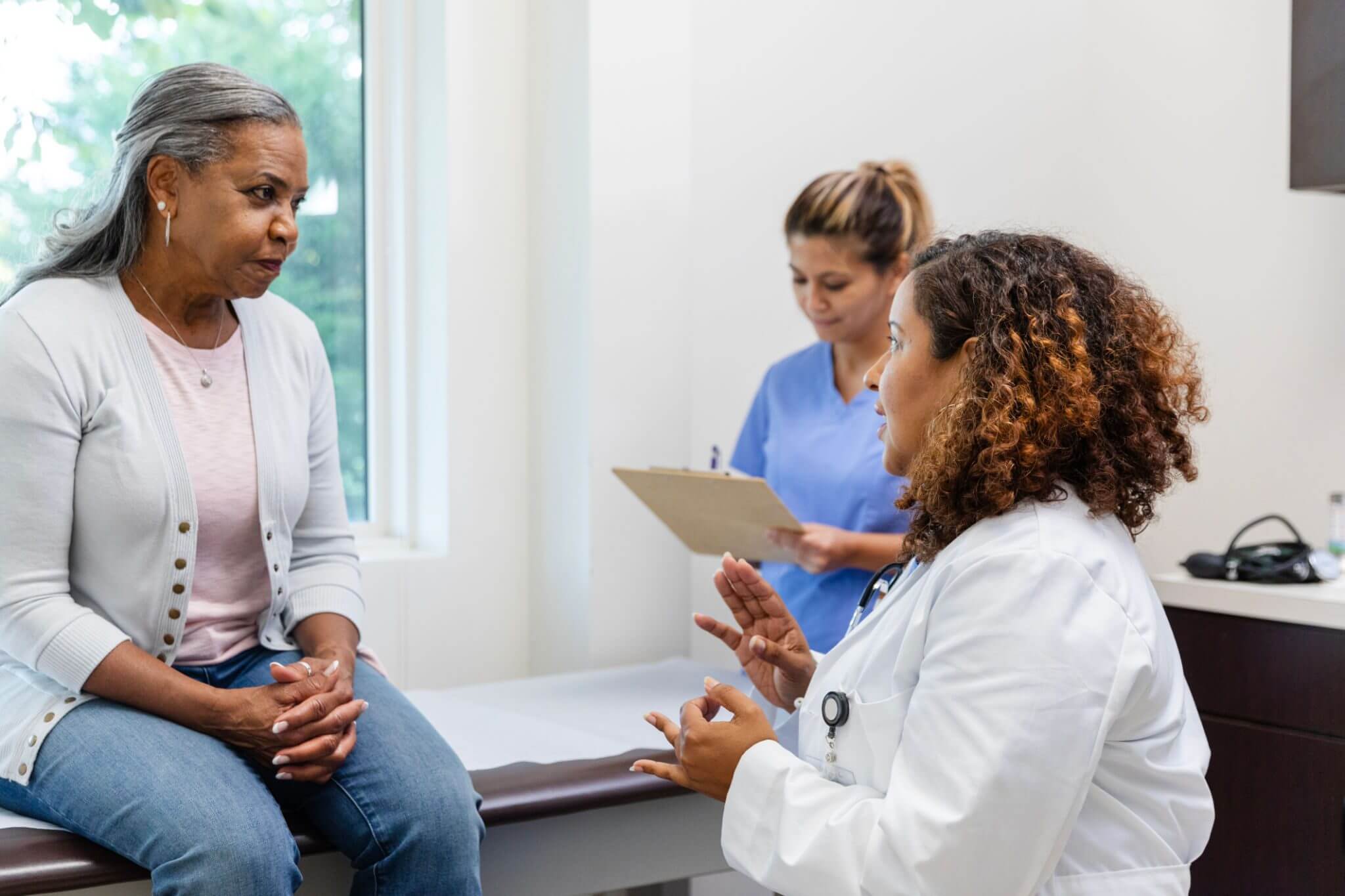 Doctor consulting with patient in medical office.